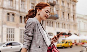 Woman at work with her natural red hair tied back in a smart ponytail